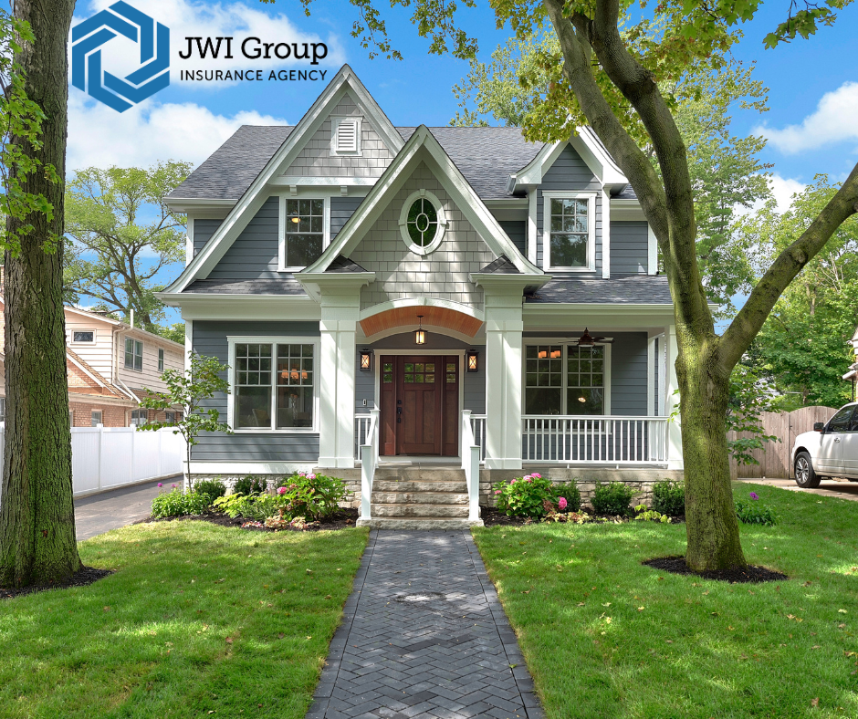 Two-story suburban home with gray siding, white trim, and a manicured front lawn in Westchester County, NY