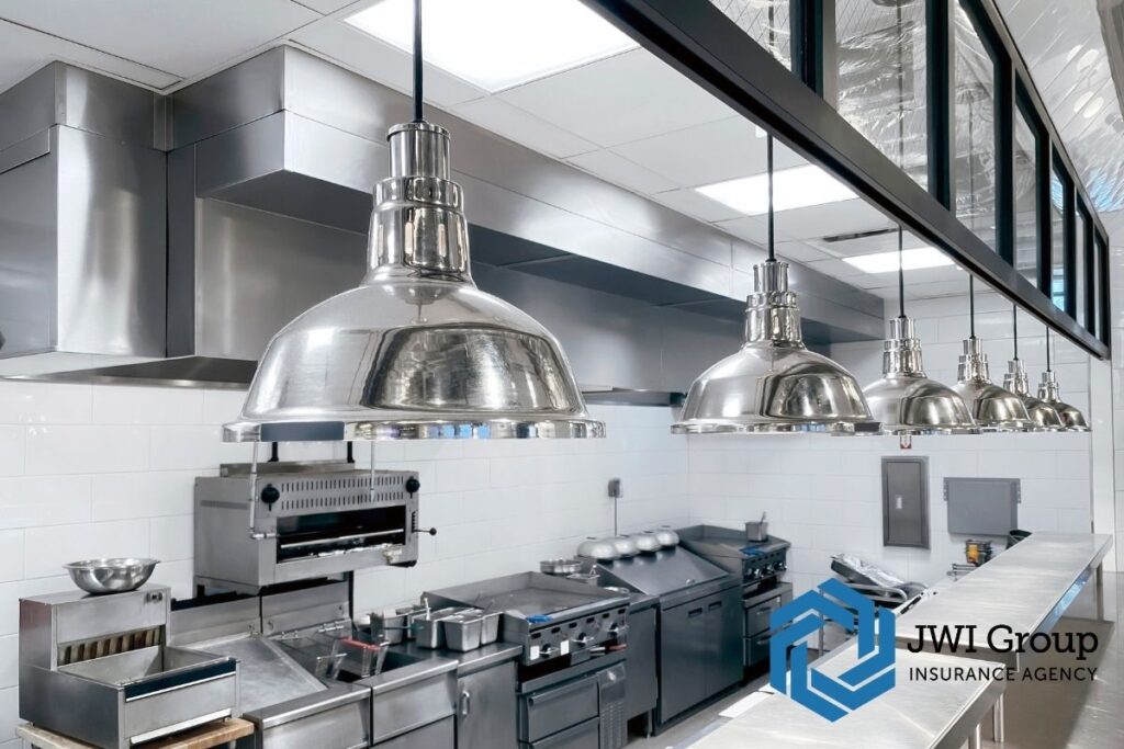 Commercial restaurant kitchen with modern fire suppression system and stainless steel equipment, reducing fire risk for insurance underwriting.