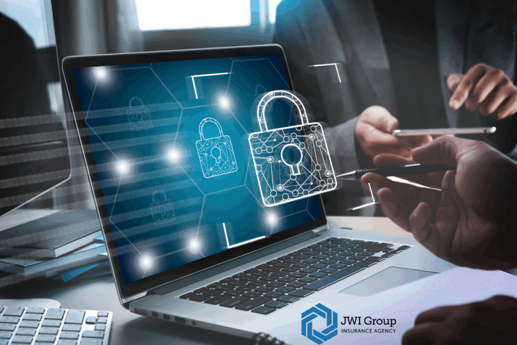 Business professionals reviewing cybersecurity protections with a laptop screen showing digital padlocks, representing stricter underwriting standards and cyber risk management.