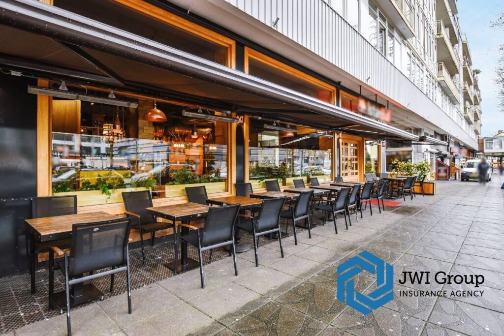 Exterior of restaurant with outdoor seating, lighting, and security features that influence restaurant insurance underwriting decisions.