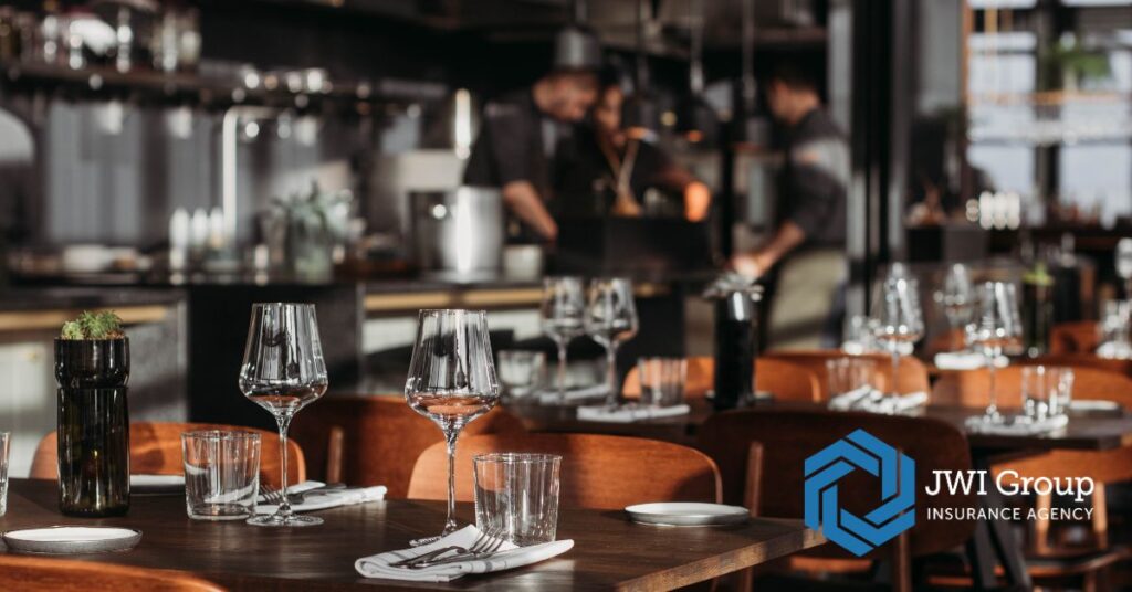 Modern restaurant dining room with warm lighting and neatly set tables, representing restaurant insurance risk management.