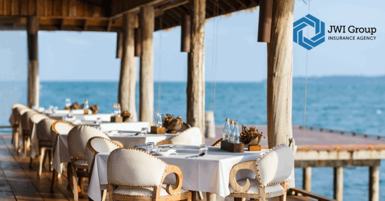 Outdoor seaside restaurant with elegant table settings, highlighting the variety of restaurant environments that require tailored insurance solutions.