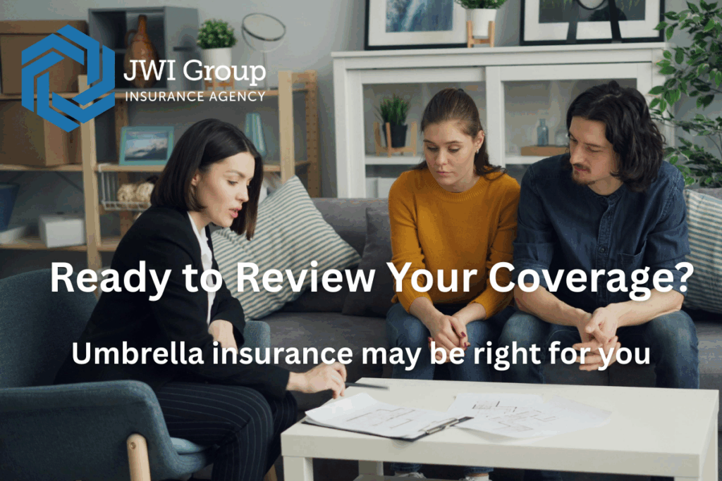 Couple reviewing documents with insurance agent, discussing umbrella coverage.