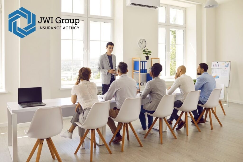 Nonprofit board members meeting in a conference room, illustrating governance responsibilities and the need for D&O insurance.